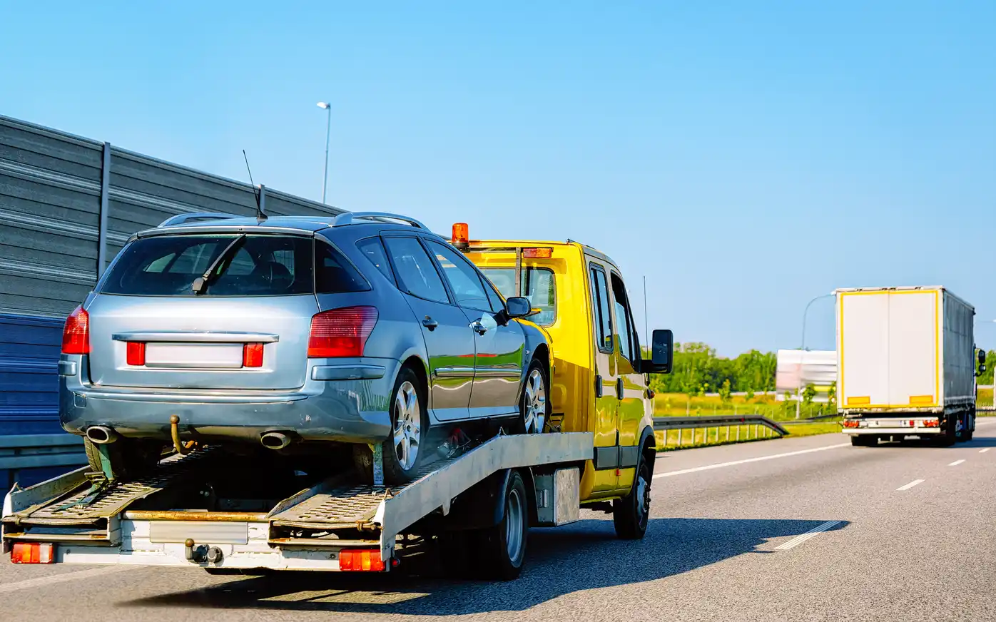 Car towing service in Melbourne with a Southern Towing tow truck safely loading a damaged vehicle